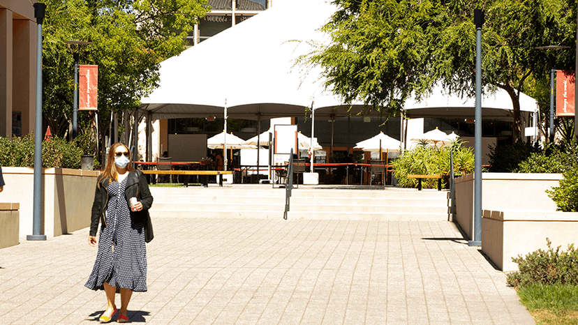 Woman in mask on empty campus during the COVID pandemic